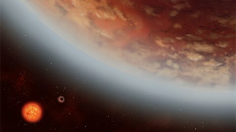 Concepção artística do K2-18b orbitando uma anã vermelha na constelação de Leão